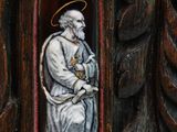 a statue of a man with a halo in a wooden frame