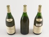 three bottles of wine sitting next to each other on a white surface