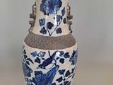 a blue and white vase sitting on a table