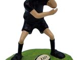 figurine of a man with a rugby ball in his hand