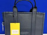 a black handbag with a yellow tag on it