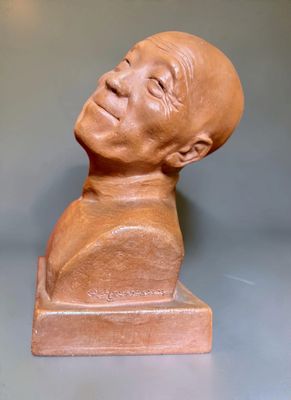 a clay sculpture of a man with a bald head