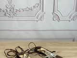 a pair of women ' s sandals on a wooden table in front of a wall