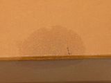 a close up of a brown box with a brown spot on it