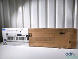 a cardboard box sitting on top of a table next to a keyboard
