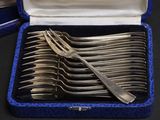 silverware in a blue case on a table with other silverware in it