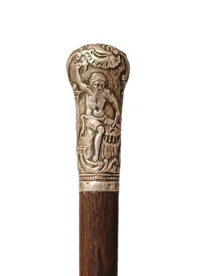 une image représentant une canne en bois ornée d'une sculpture
