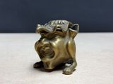 a close up of a statue of a dog on a table