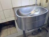 a sink in the corner of a public restroom