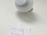 a small white object on a table next to a sign