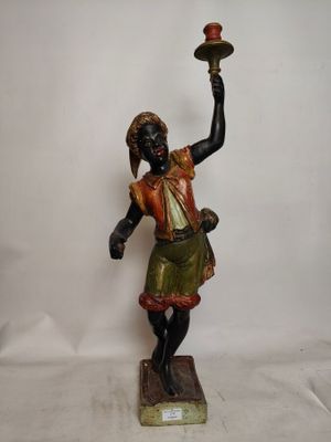 statue d'une femme tenant une bougie à la main, posée sur un socle en marbre