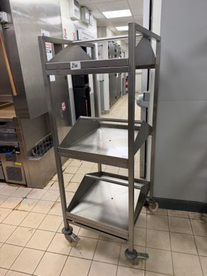 a metal cart that is sitting in the middle of a kitchen