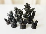 a lot of small black figurines sitting on a table