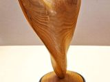a wooden sculpture that is on a table