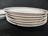 several white plates stacked on top of each other on a table