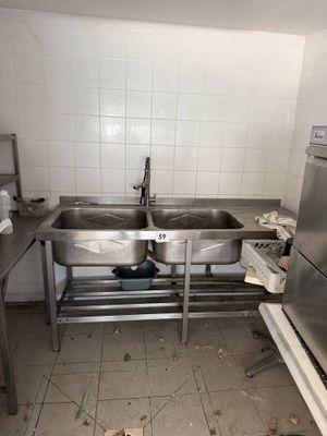 an image of a kitchen with a sink and a refrigerator