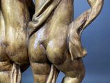 statue of a couple of nudes hugging each other on a marble base