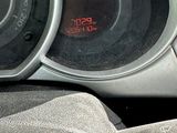 a close up of a car dashboard with a clock on it