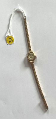 a small watch that is on a white table