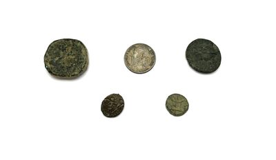 plusieurs types de pièces de monnaie sont présentés sur une surface blanche