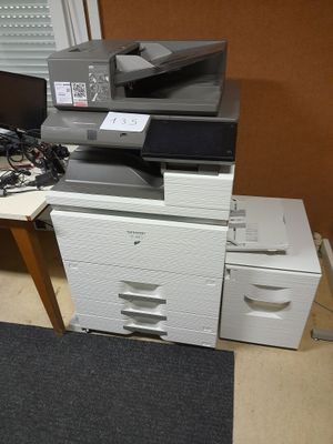 a pile of office supplies on a desk in a room