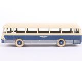 a small blue and white bus on a white surface