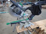 a miter saw that is sitting on top of a piece of wood