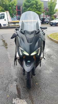 a motorcycle that is parked on the street in the rain