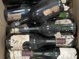 many bottles of wine in a box on the table