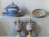 three vases sitting on a shelf next to a bowl and saucer
