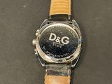 a close up of a watch with a leather band