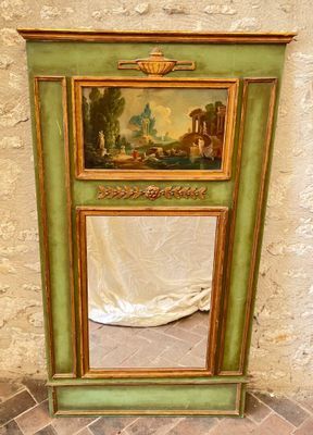 a green cabinet with a painting on the top of it
