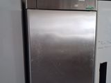 a silver refrigerator and a white refrigerator freezer in a kitchen