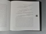 an open book with a picture of a cat sitting on top of it
