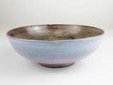 a blue and brown bowl on a white table