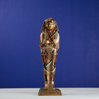 an egyptian statue of a woman holding a baby in her arms