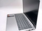 a silver laptop computer sitting on top of a white table