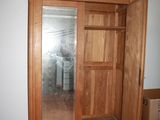 a wooden armoire with a mirror in it