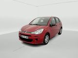the small red car is parked in a white room