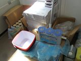 many boxes and containers on the floor in the room