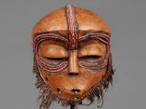 an image of a wooden mask on a stand