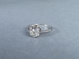 a close up of a diamond ring on a blue surface