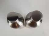 pair of stainless steel knobs on a white surface
