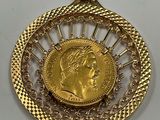 a close up of a gold coin with a chain around it