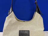 a close up of a purse on a table with a blue background
