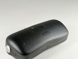 the case is made of black leather and has a silver button on the side