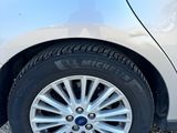 a close up of a car ' s tire on a gravel road