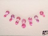 a picture of a necklace made of pink stones