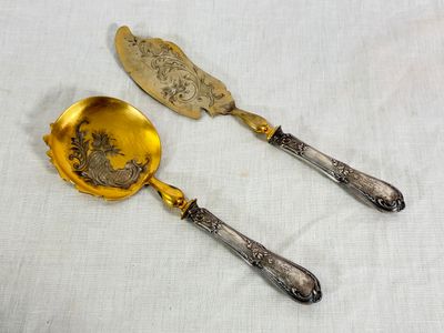 pair of antique silver plated serving utensils with floral design