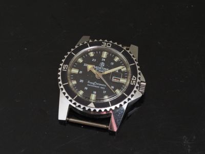 a watch that is sitting on a black surface